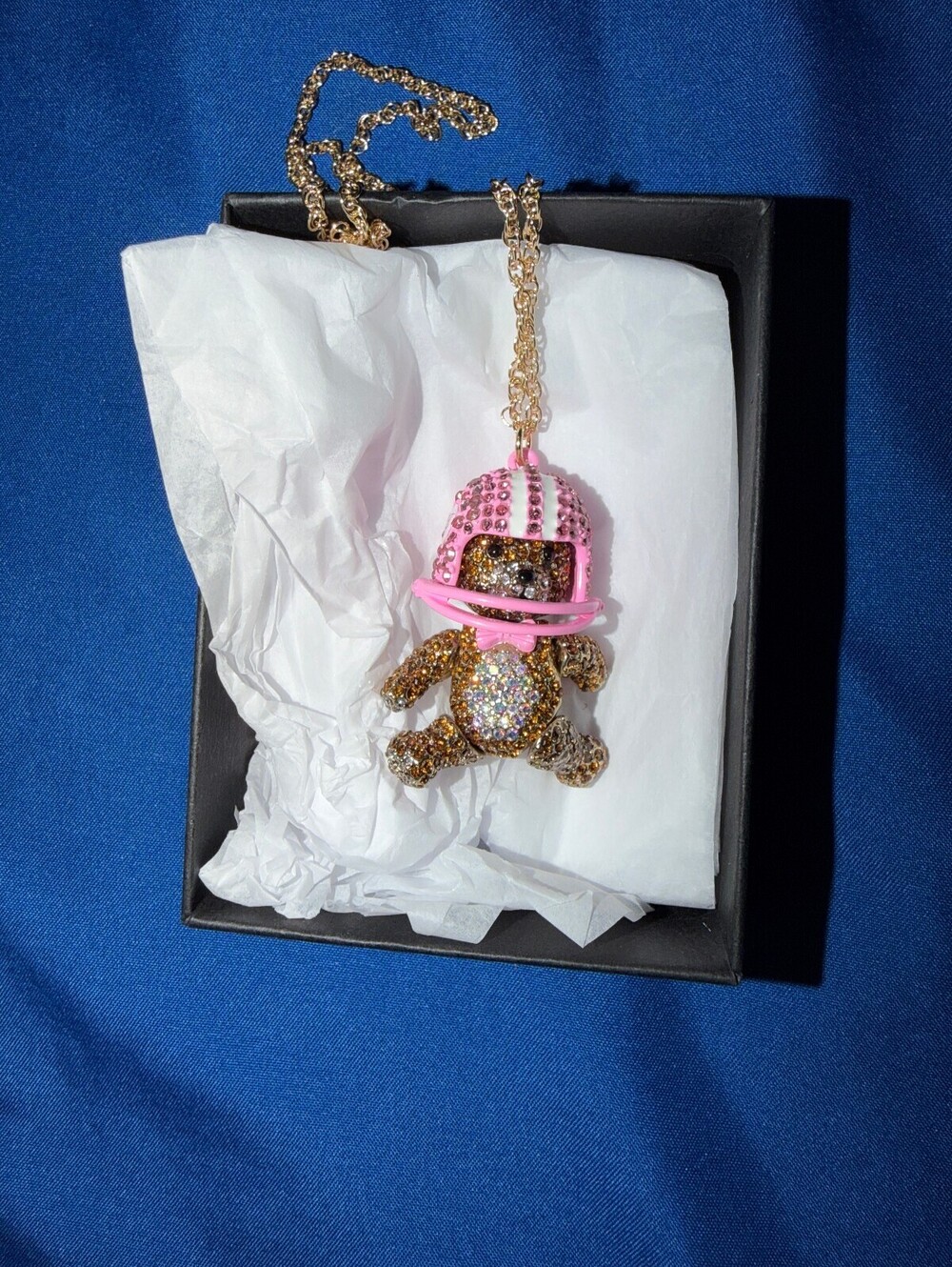 Betsey Johnson’s Sparkling Teddy Bear Pendant Necklace with Pink Helmet Charm